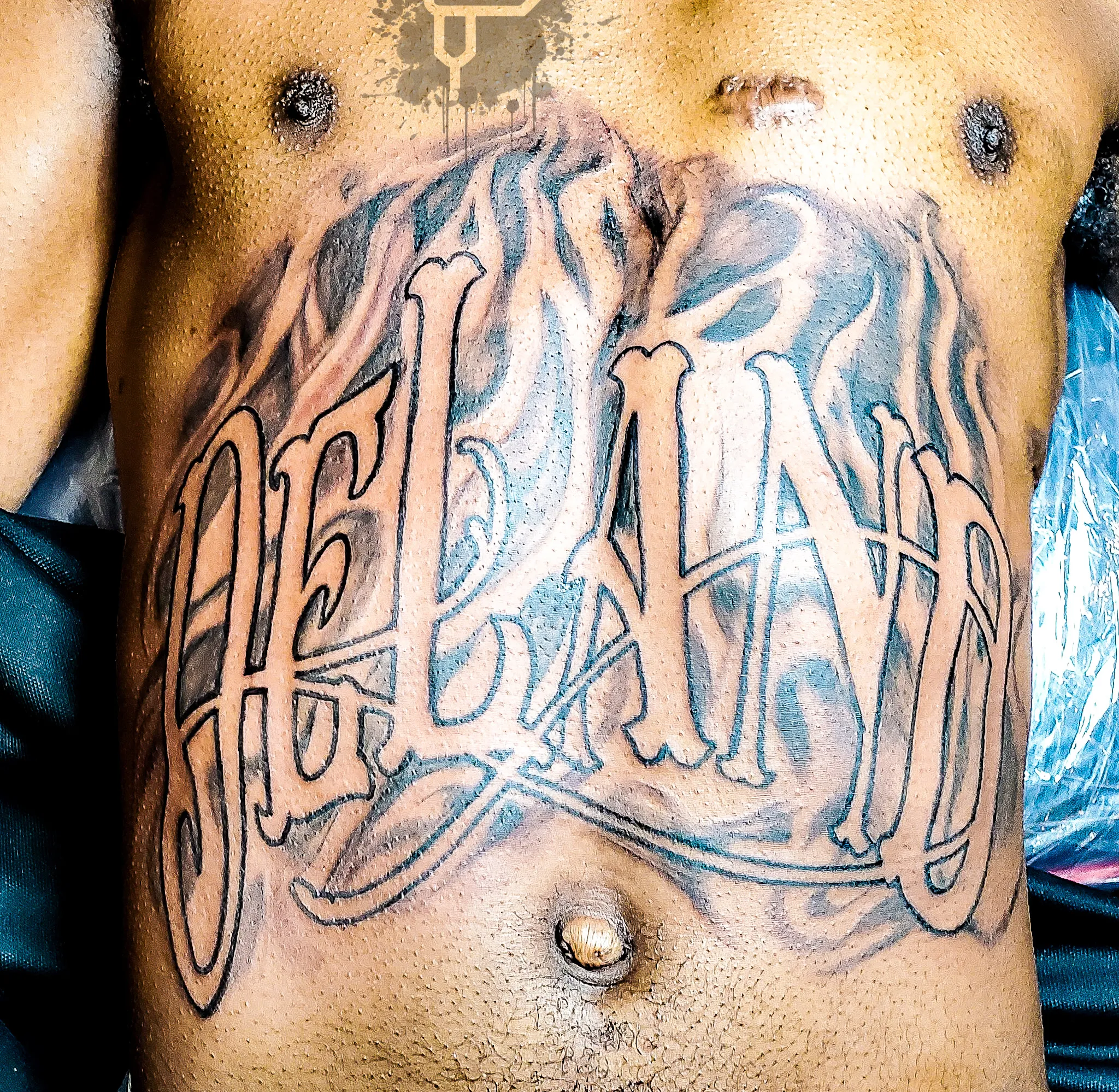 080-Black and Gray Script _Deland_ Torso Tattoo – Daniel Collins – Premium Tattoo Artistry