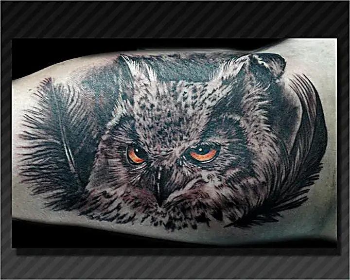 Wisdom in ink: Black and gray owl tattoo with piercing orange eyes.