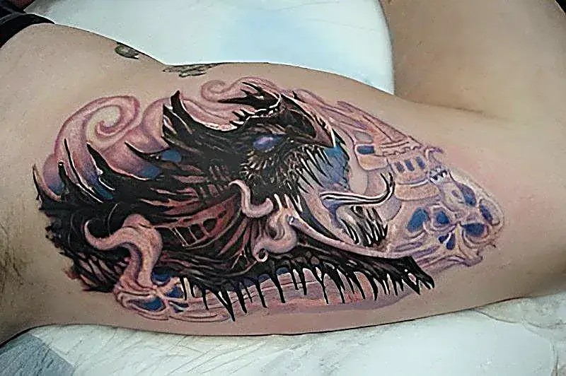 Fantasy unleashed: Dragon tattoo with castle and smoke on the upper arm.