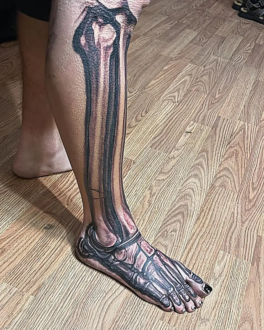 Anatomy in ink: Realistic skeleton tattoo on the lower leg and foot.