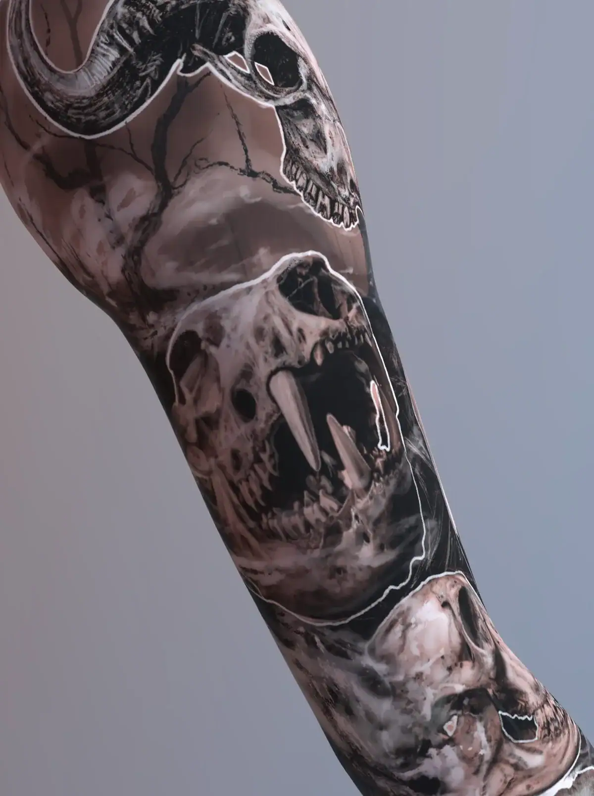 Black and gray sleeve tattoo with multiple skulls including fanged and horned animal skulls